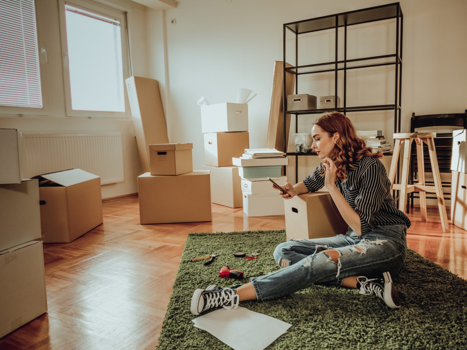 Generation Z woman sitting in the living room of her new home.