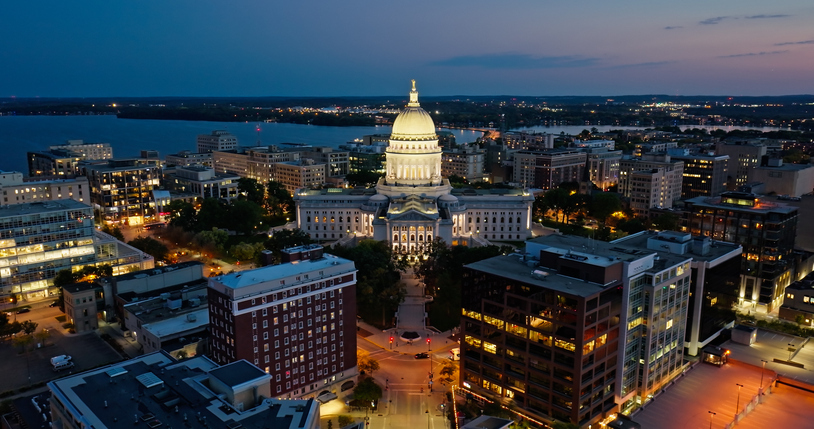 An image of Madison, WI at night featuring their government center.