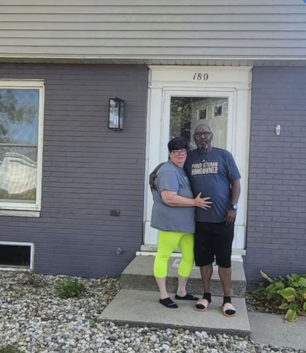 picture of Rico R. in front of a house
