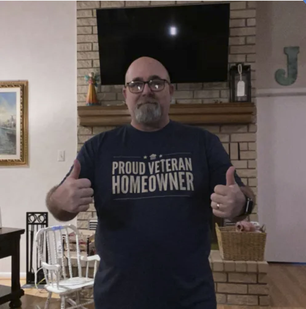 picture of Herbert J. in front of a house